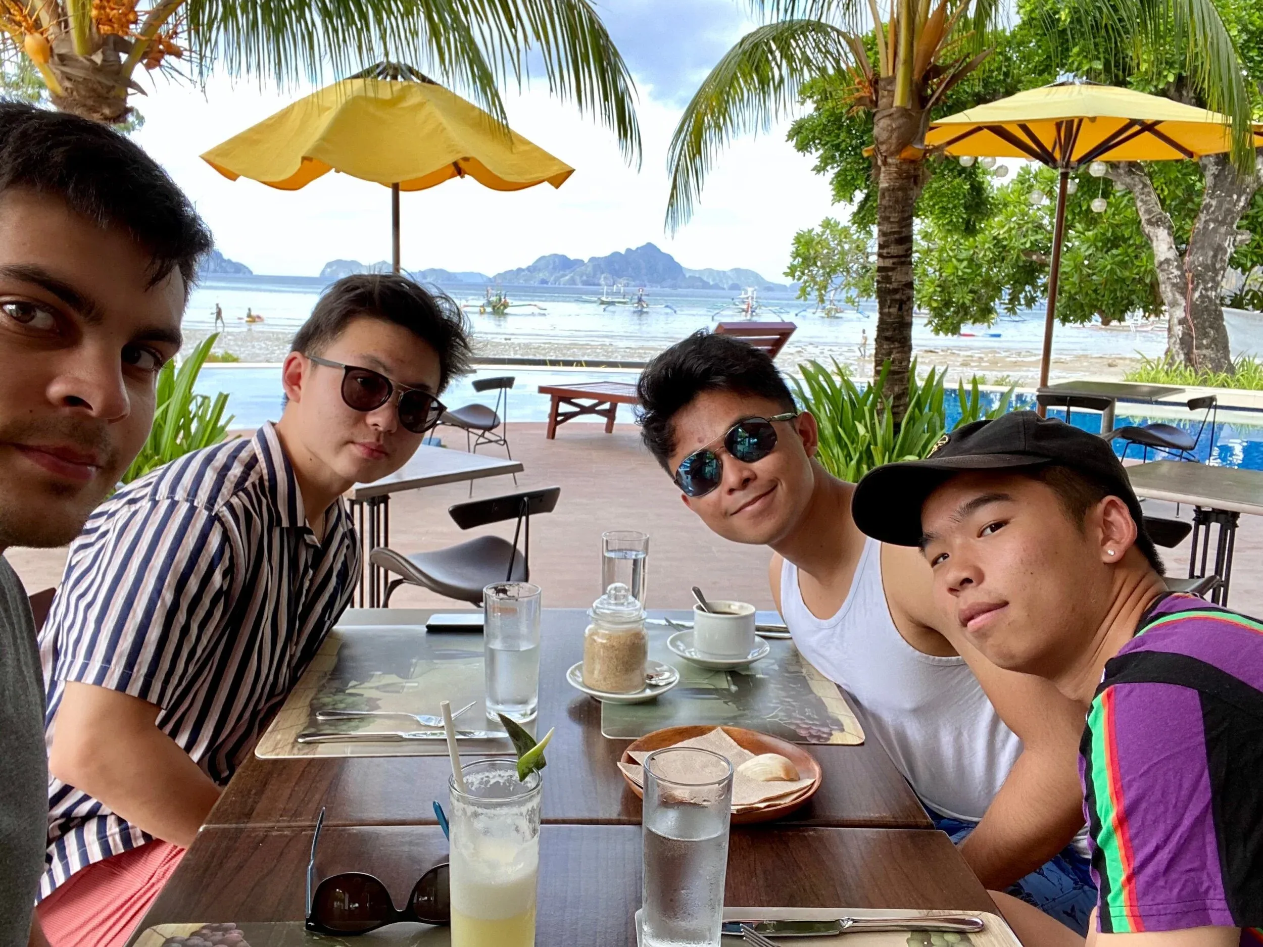 Breakfast with fresh pineapple juice, eggs, and sausage.