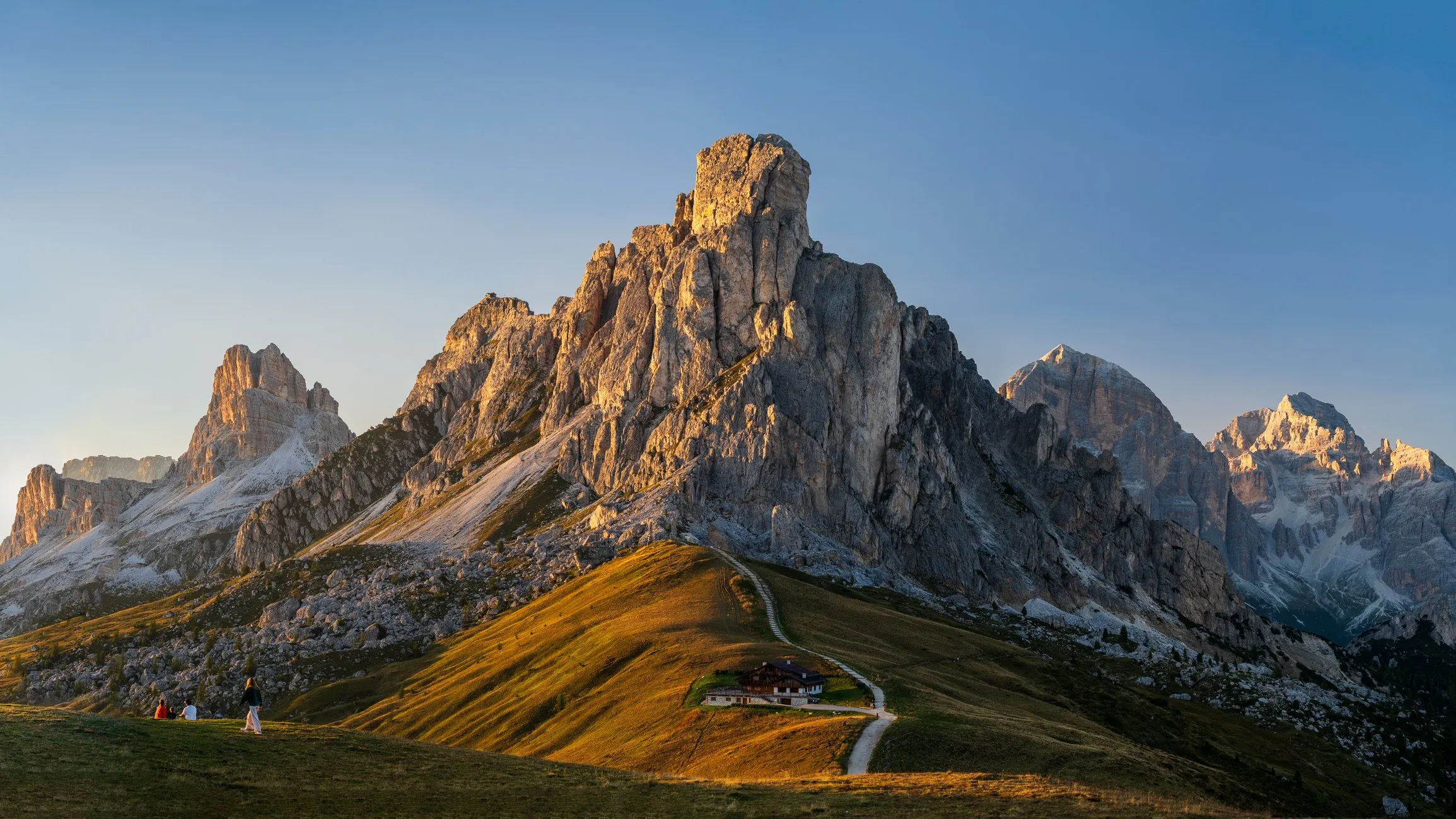 Alpine trail leading toward dramatic rock towers.