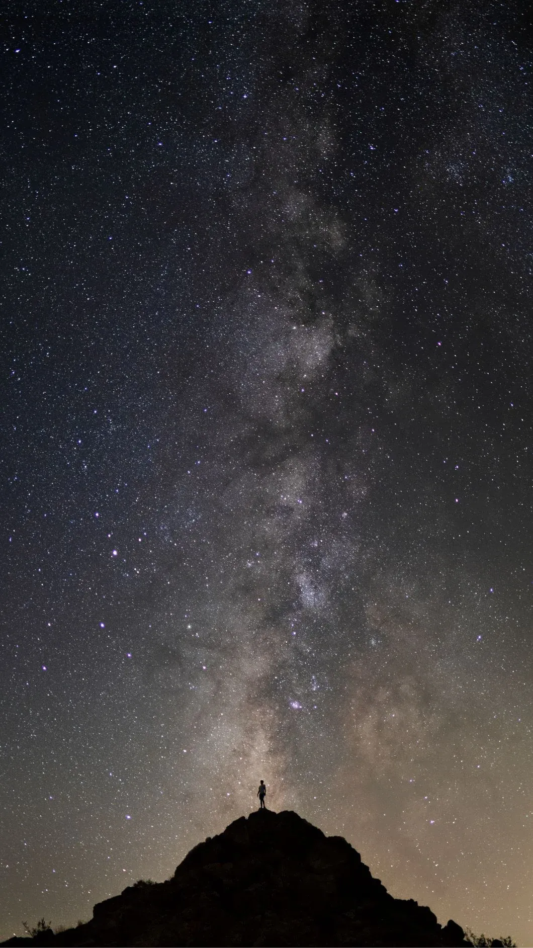 Star-filled sky over a remote campsite.